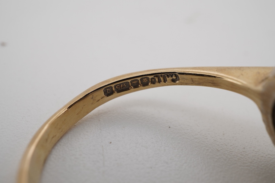 A modern 9ct gold and three stone sapphire set dress ring, with sapphire and diamond chip set border, size Q.